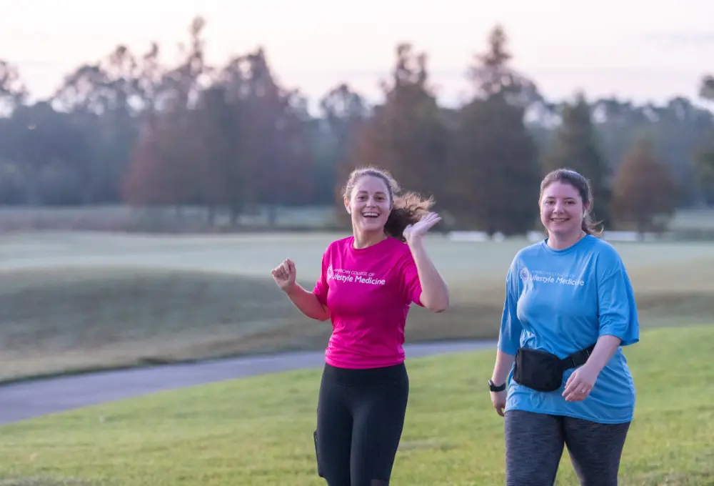 Two women jogging and smiling